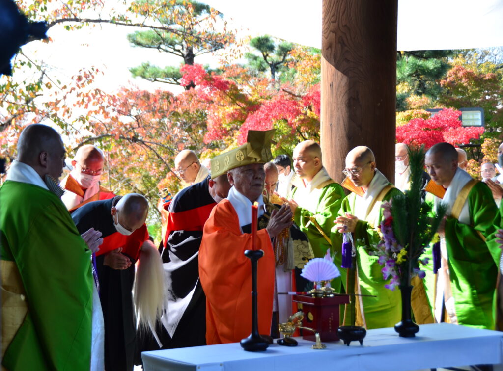 練り行列の途中、山門前で行われた開門式の様子。境内は紅葉が美しく彩り、秋の深まりとともに緋色に色づく京都を感じさせた